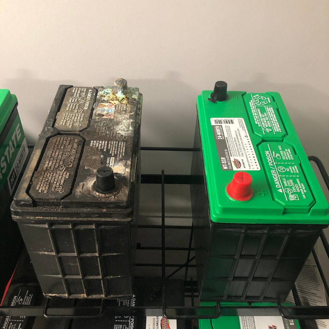 car battery with corroded battery terminals compared to a new battery