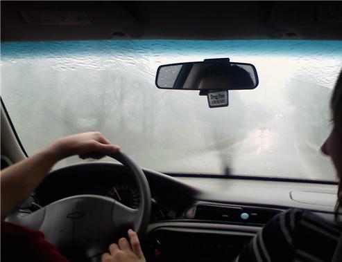 foggy car windshield during heavy rain