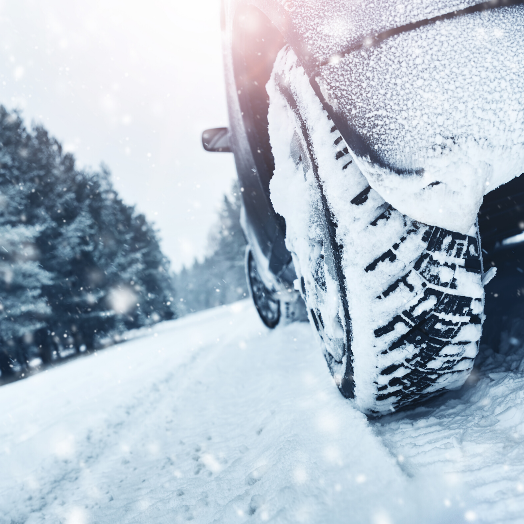 car driving through snow with normal tires, resulting in tire treads full of snow