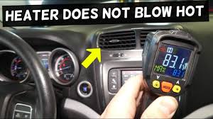 temperature scanning gun pointed at a car's air vents